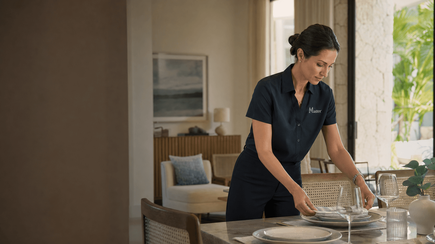 Master Vacation Homes hospitality professional arranging a dining table in a vacation home